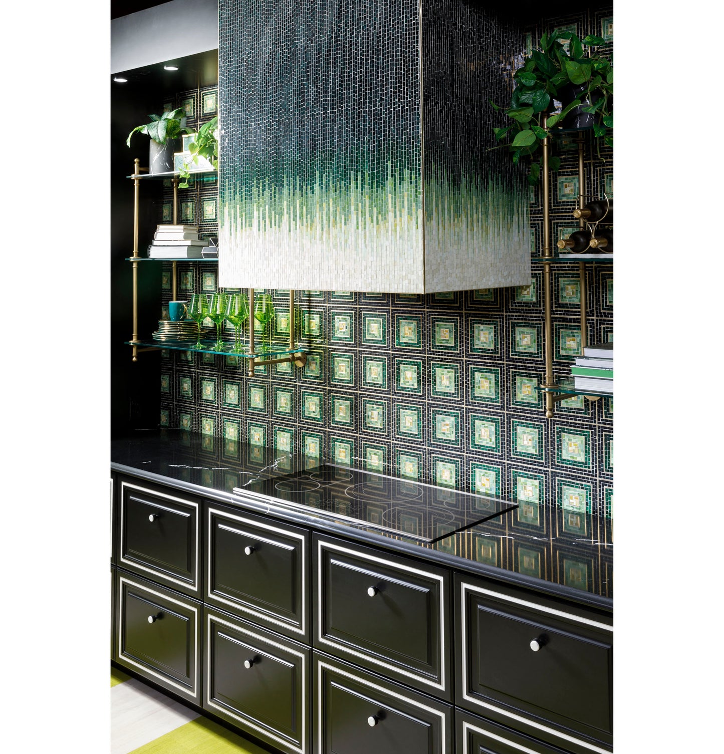 Black glass 36-inch touch-control electric cooktop installed on black cabinetry with green and gold patterned tile backsplash