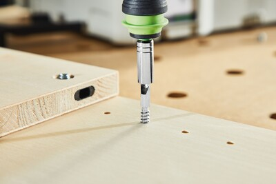 Metal corner connector screw being installed into wooden boards for woodworking tool accessories and home improvement projects