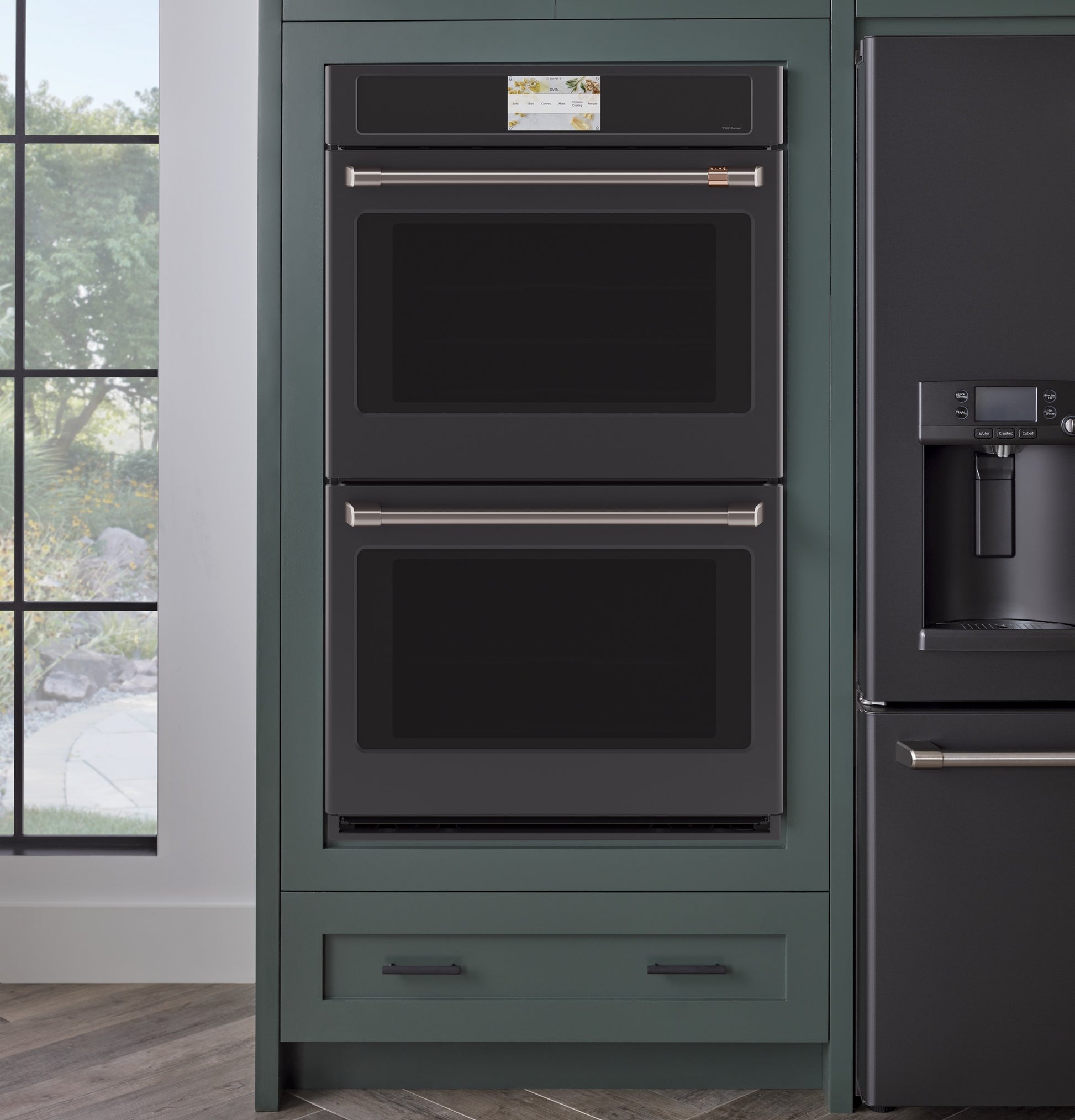 Built-in double wall oven with sleek black finish and stainless steel handles in a modern kitchen setting