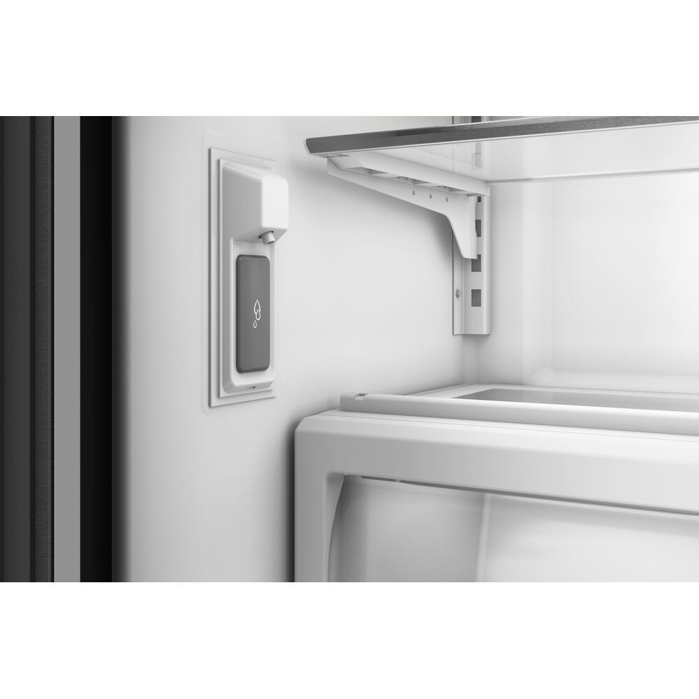 Close-up of internal water dispenser and adjustable shelving inside a KitchenAid French door refrigerator interior