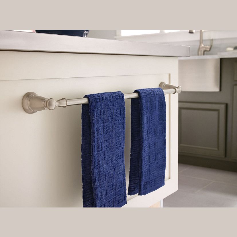 Brushed nickel wall-mounted towel bar with two navy blue textured hand towels in modern bathroom setting