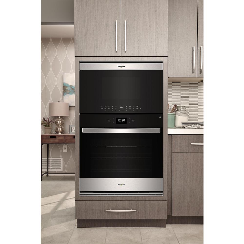 Built-in stainless steel microwave and wall oven combo installed in modern kitchen cabinetry from appliances collection