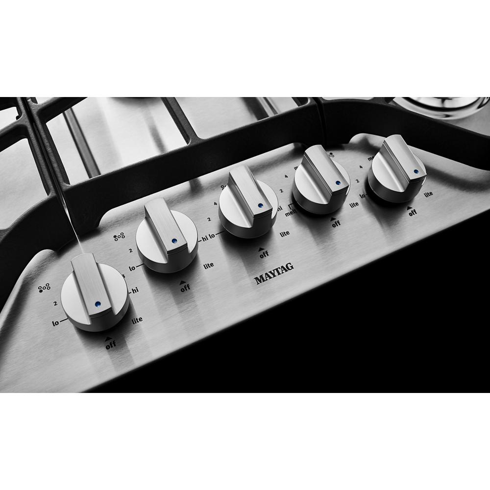 Set of five stainless steel control knobs on a 36-inch gas cooktop with DuraGuard protective finish from kitchen appliances collection