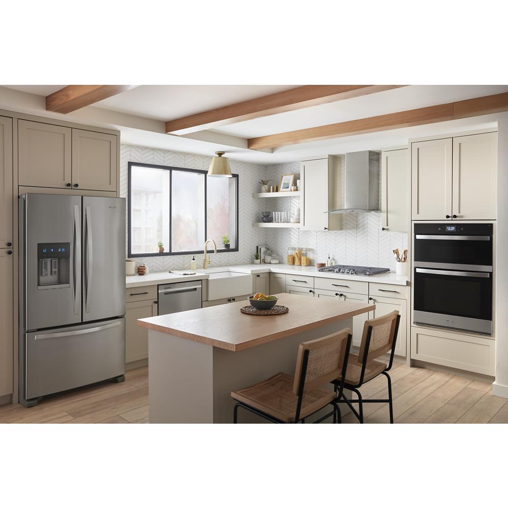 Modern kitchen featuring a stainless steel wall oven microwave combo and matching appliances in a bright home improvement setting