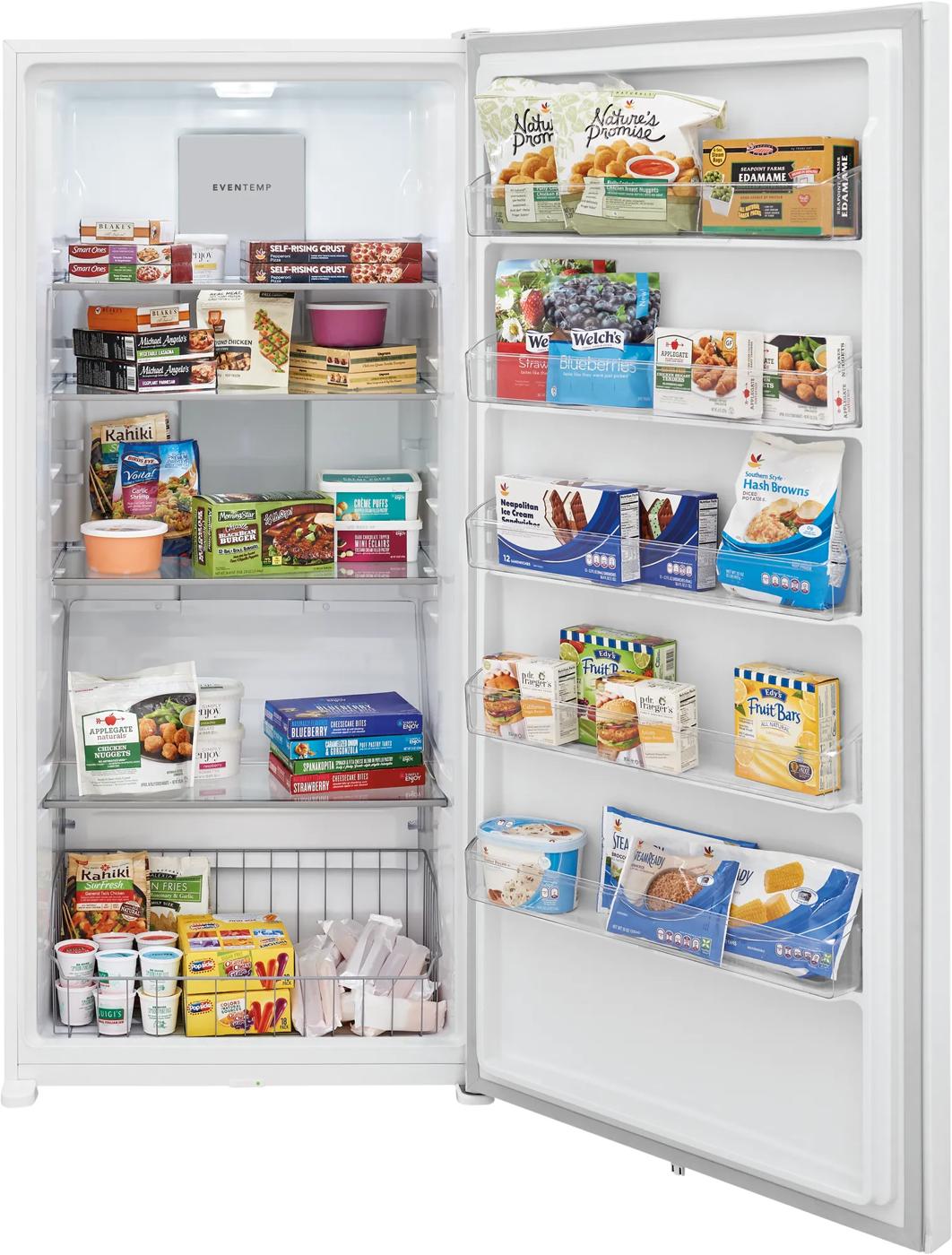 Open white upright freezer filled with various frozen food products in Freezers & Ice Makers and Appliances collections