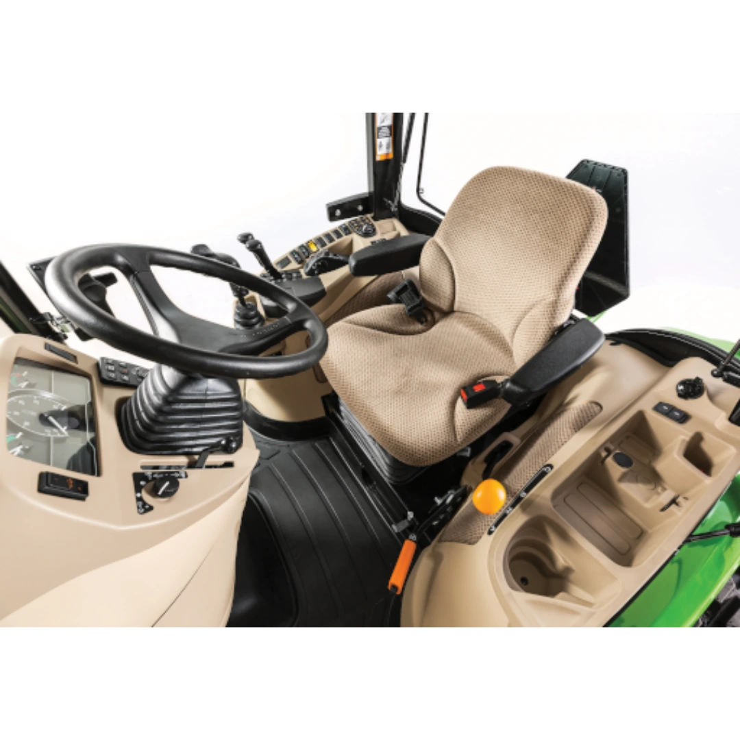 Interior view of the operator station in a John Deere 4075R Compact Tractor with ComfortGard Cab, showing beige seat, steering wheel, and control levers in outdoor power equipment.