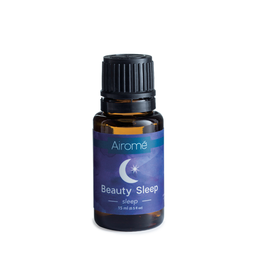 Small amber glass bottle of Airome essential oil blend labeled for promoting restful sleep and relaxation
