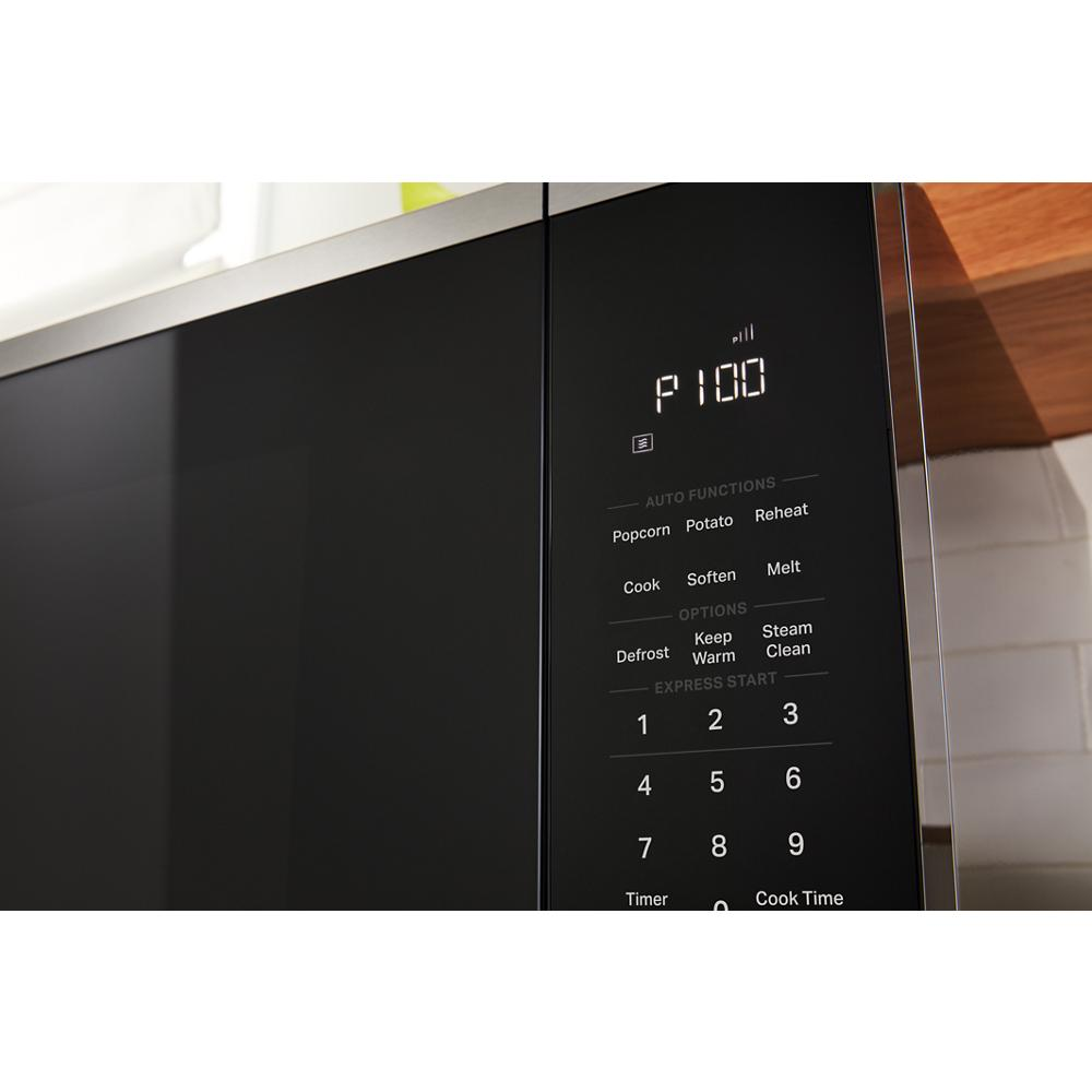Close-up of digital control panel on black sensor cooking microwave showing auto functions and numeric keypad
