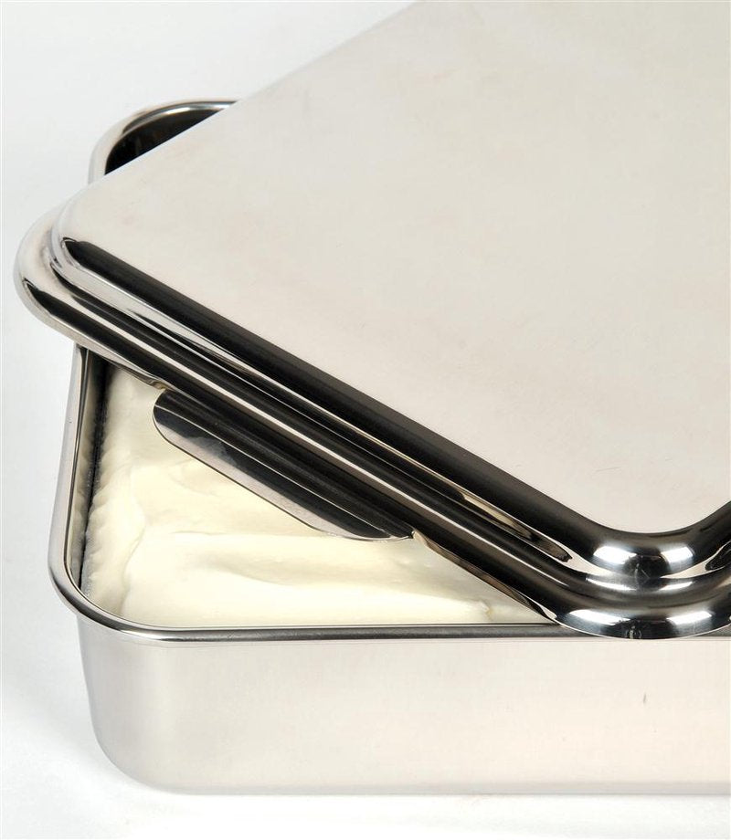 Rectangular stainless steel cake pan with partially lifted lid showing smooth creamy filling inside Kitchenware bakeware collection