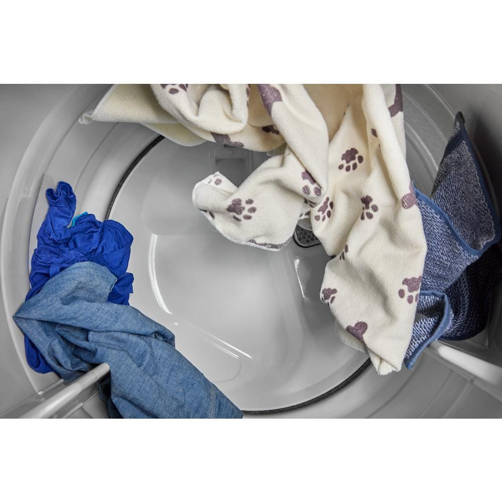 Interior view of smart top load dryer drum containing blue and beige clothes with paw print pattern in appliances collection