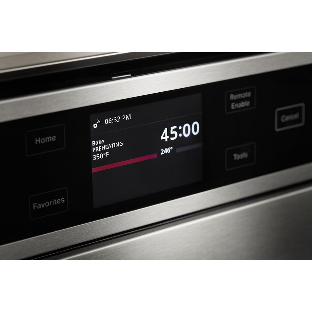Close-up of stainless steel smart wall oven digital control panel showing bake preheat at 350°F with timer and temperature details