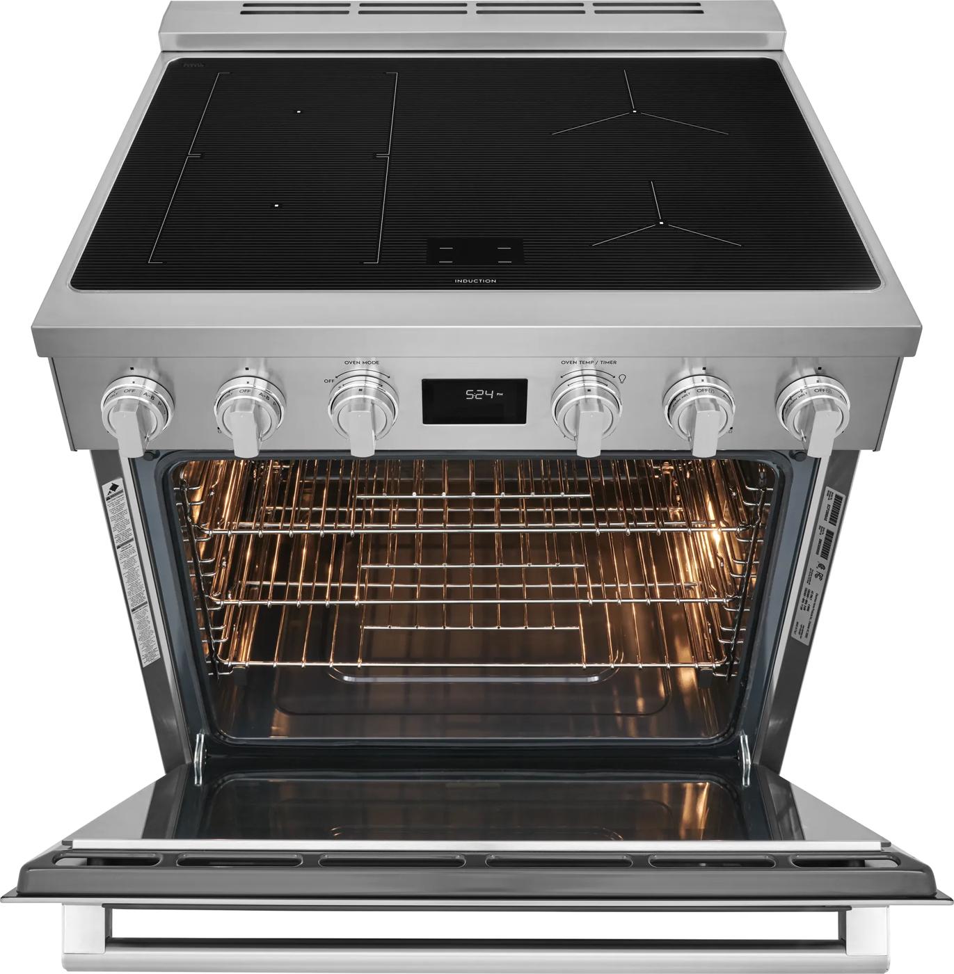 Front view of stainless steel induction range with open oven and digital display in kitchen appliances collection