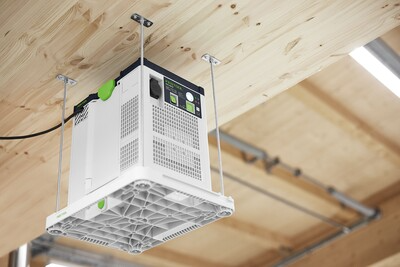 White plastic and metal ceiling mount bracket with rods securing an air purifier for woodworking tools and dust filtration collections