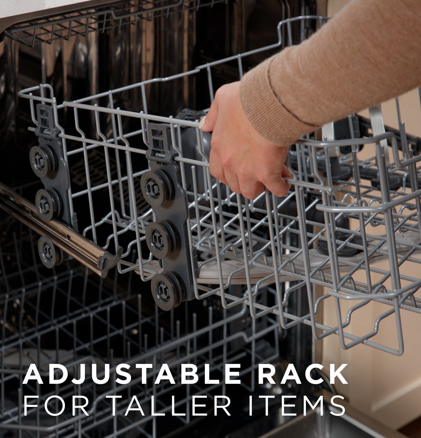 Hand adjusting dishwasher rack height inside stainless steel interior in kitchen appliances and dishwashers collection