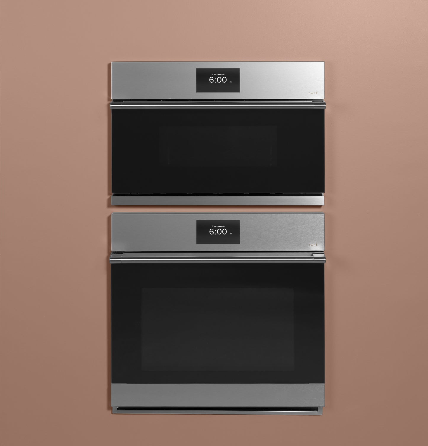 Two platinum glass smart wall ovens with digital displays stacked in a minimalist kitchen appliance setting
