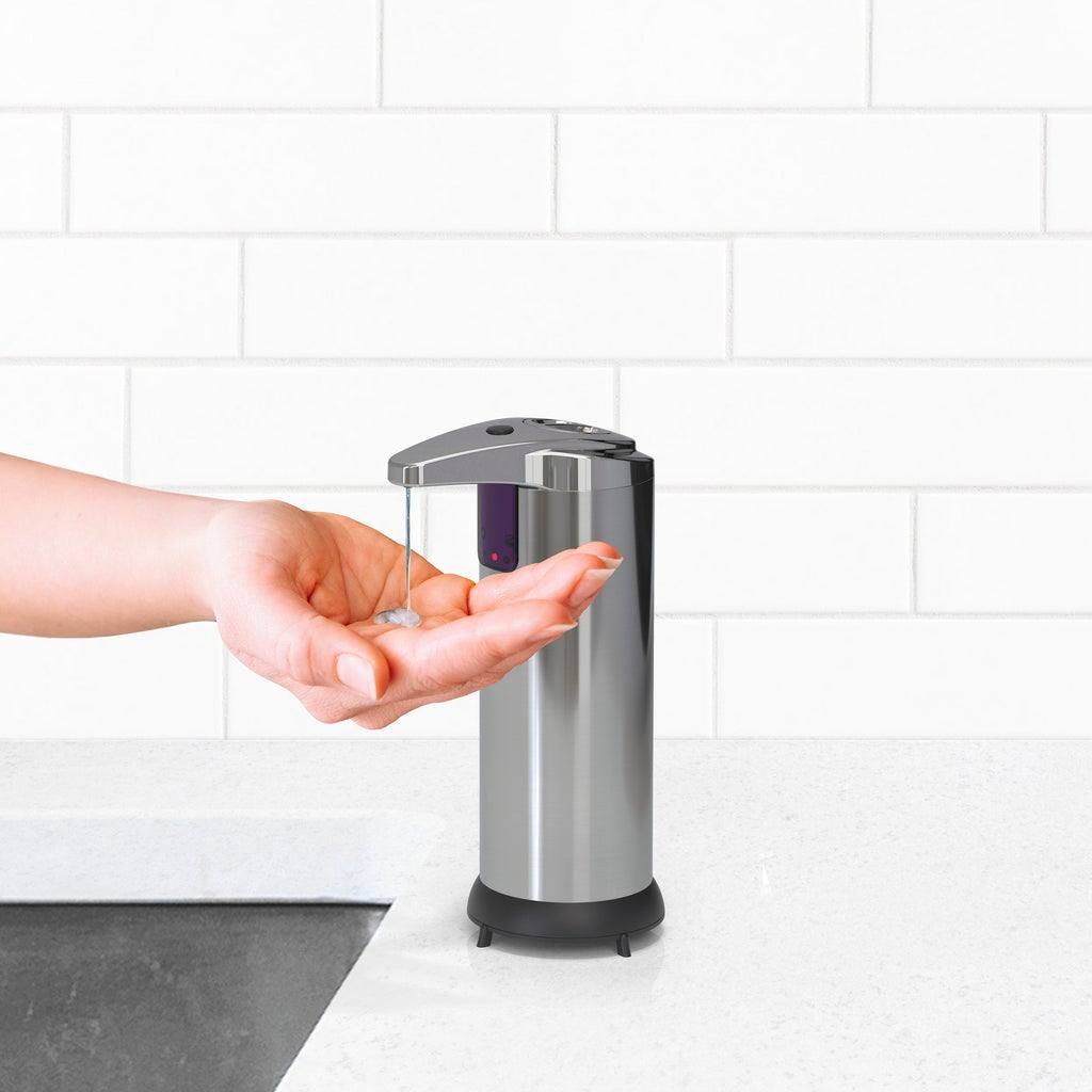 Sleek stainless steel soap dispenser dispensing liquid soap onto hand in bathroom setting for safety use