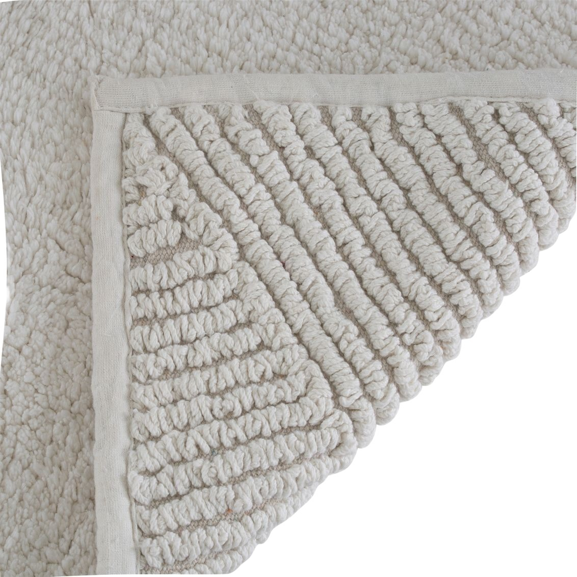 Natural-colored bath mat corner showing soft plush texture and reversible design for bathroom safety and comfort under $50 collections