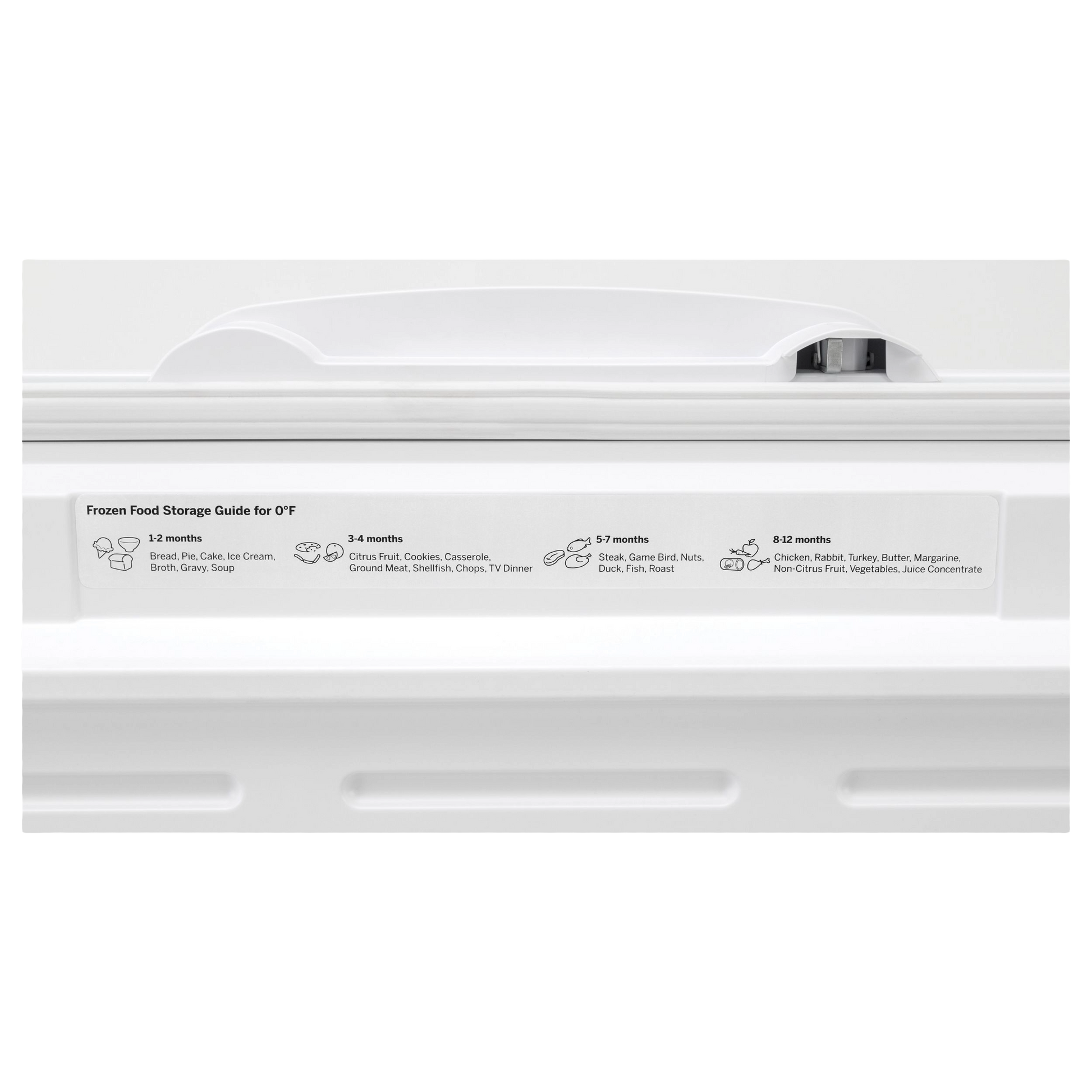 White chest freezer lid handle with frozen food storage duration guide label in kitchen appliance setting