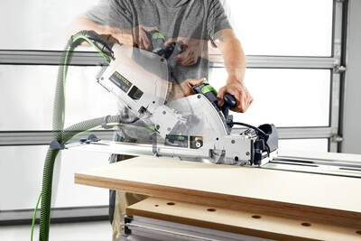 Person operating Festool plunge cut track saw with 75-inch guide rail for precise home improvement and woodworking tasks