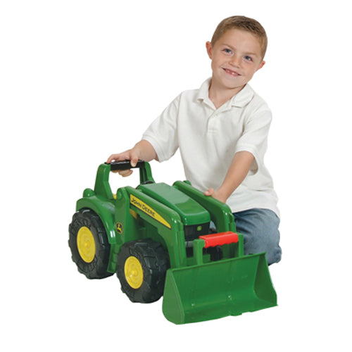 Child sitting behind green and yellow toy tractor with large front scoop from Vehicles & Remote Controlled Toys collection
