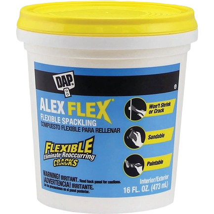White plastic container of flexible acrylic spackling with yellow lid for home repair and crack filling projects