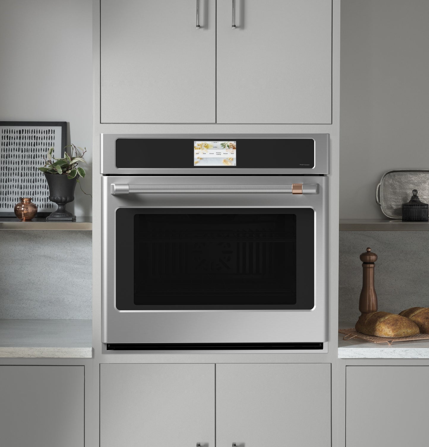 Built-in stainless steel wall oven with digital touchscreen and convection feature in modern kitchen setting