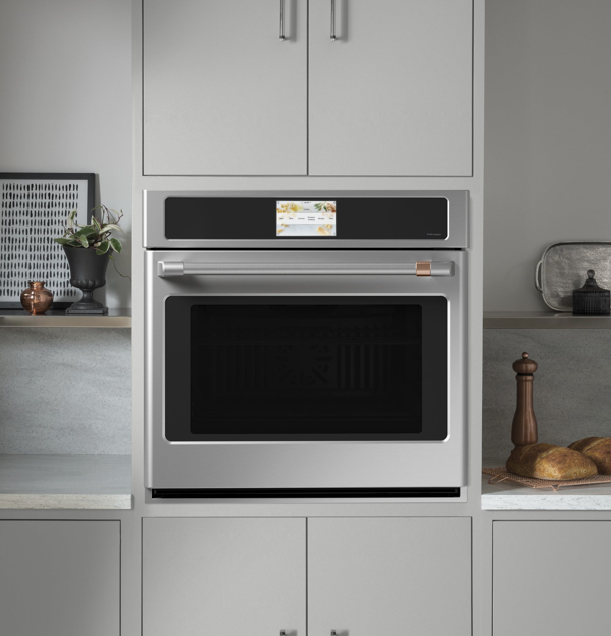 Built-in stainless steel wall oven with digital touchscreen and convection feature in modern kitchen setting
