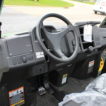 Interior view of a full-size crossover utility vehicle dashboard with steering wheel and control panel features
