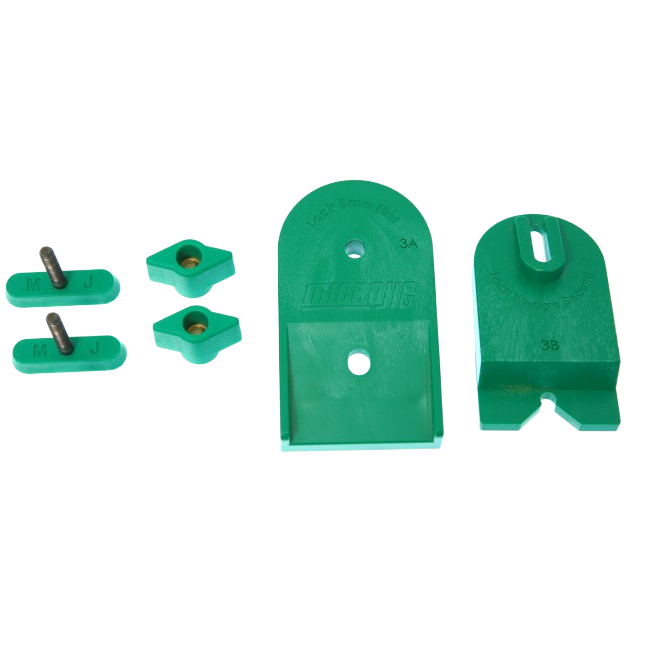 Green plastic ramp clamp components including adjustable wedges and threaded inserts for woodworking tool setup and home improvement use