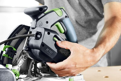 Hand operating controls on Festool plunge cut track saw for precise and clean home improvement cuts in power tools collection