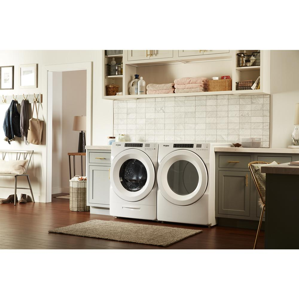 White front load dryer and matching washer with digital controls in modern laundry room, featured in home improvement and appliances.