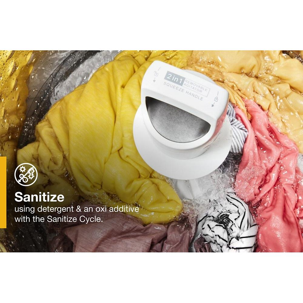 Close-up of removable agitator washing mixed colorful clothes inside a top load washer from Washers & Dryers collection