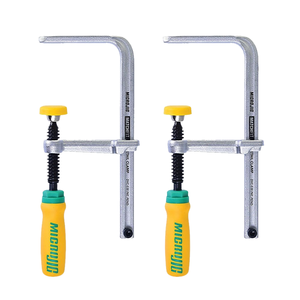 Two metal dovetail clamps with yellow and green handles designed for woodworking tool accessories and clamping tasks.