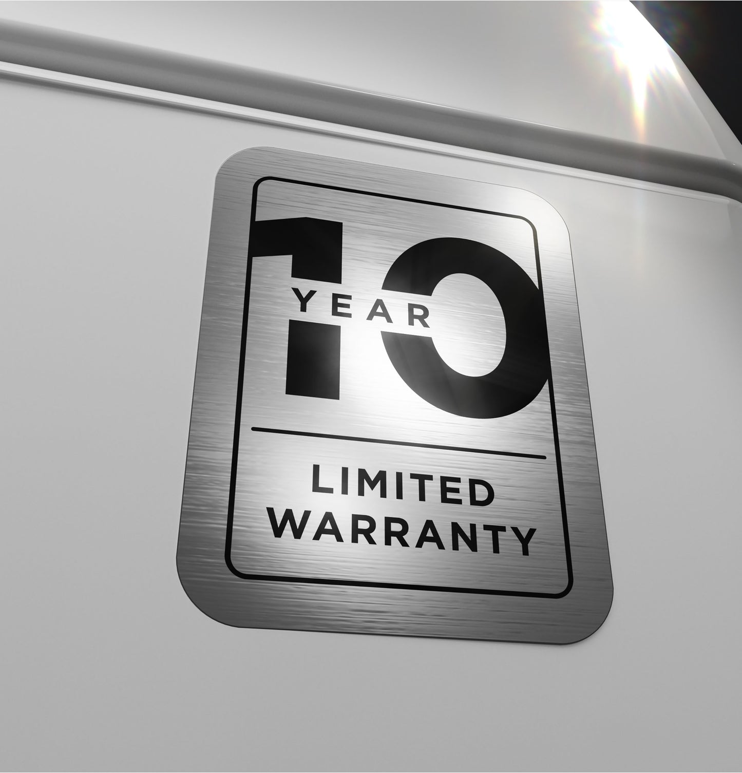 Close-up of metallic 10-year limited warranty badge on white appliance from washers and dryers collection