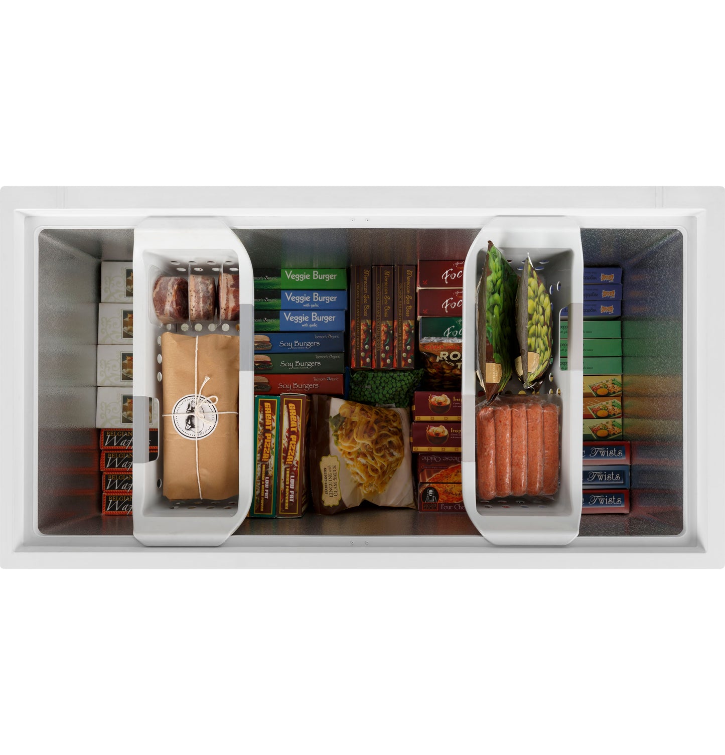 Top view of manual defrost chest freezer filled with organized frozen foods and removable interior baskets in kitchen setting
