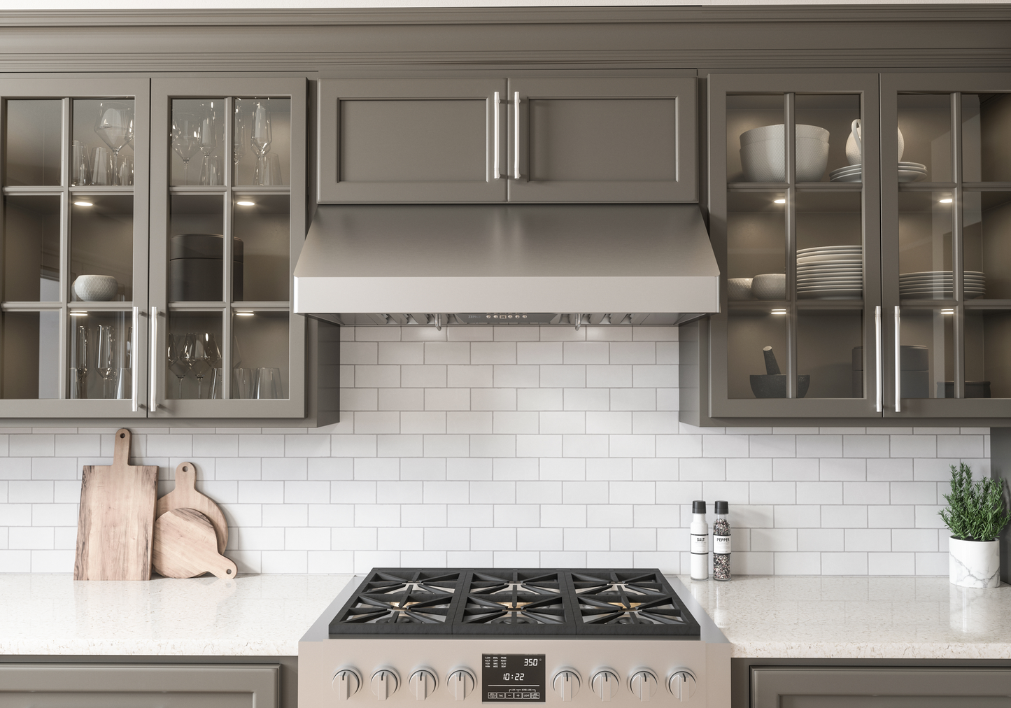 Stainless steel under-cabinet range hood with LED lighting and pro baffle filters installed above a gas cooktop in a modern kitchen setting, featured in Range Hoods, Kitchen & Kitchenware, All Products, and Appliances collections.