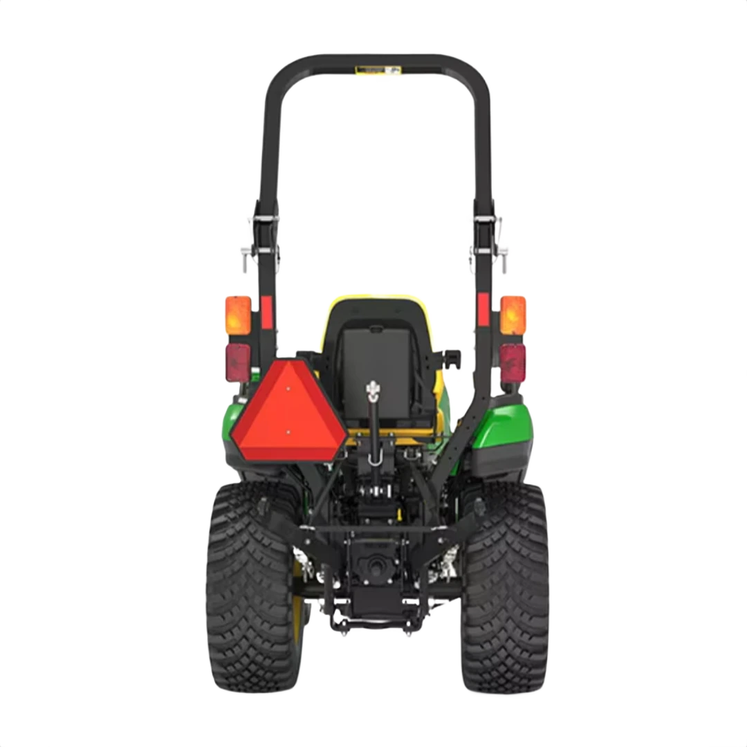 Rear view of green and yellow compact tractor with wide tires and roll bar for tools and home improvement tasks