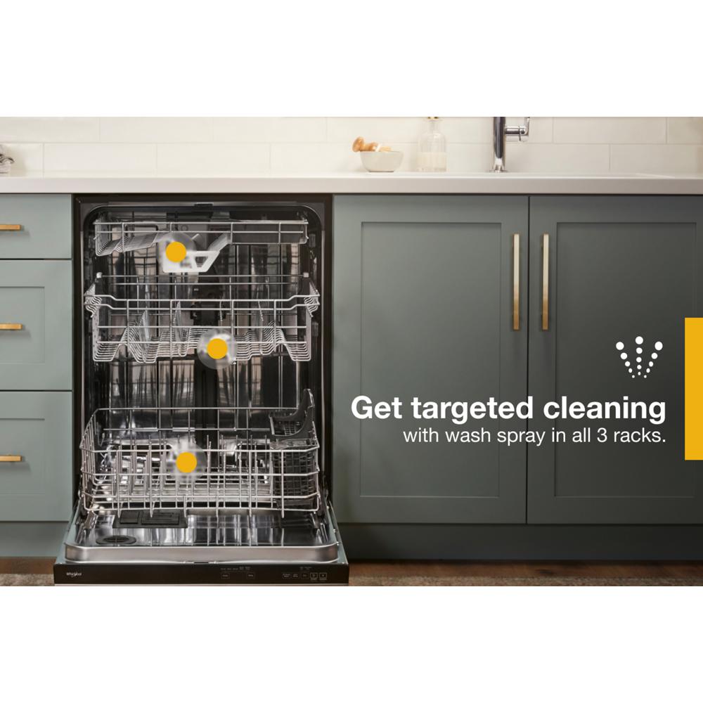 Open dishwasher with three adjustable racks inside in a modern kitchen with green cabinetry and gold handles