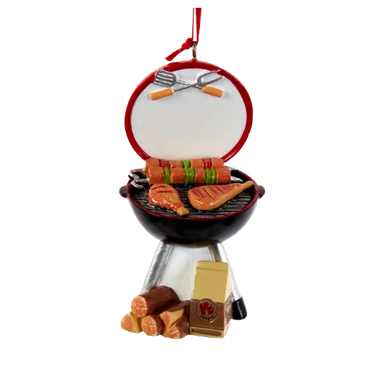 Round Christmas tree ornament shaped like a charcoal grill with meats, grilling utensils, and wood logs in holiday décor collection
