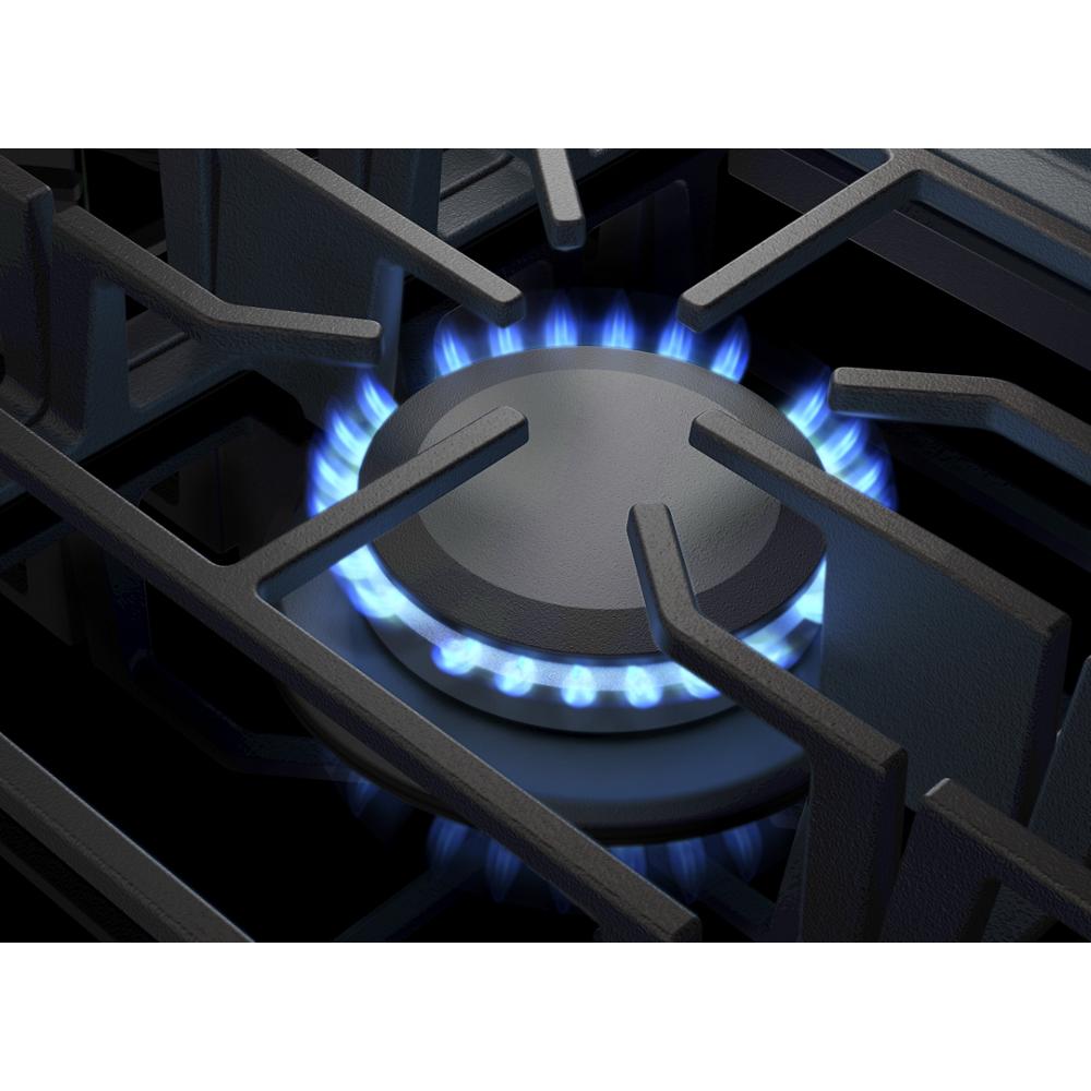 Lit burner on black glass gas cooktop with sturdy cast iron grates from Cooktops and Kitchen & Kitchenware collections