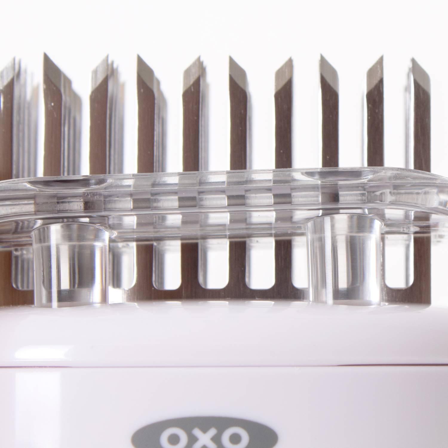 Close-up of sharp stainless steel blades on clear and white meat tenderizer for kitchenware and cooking utensils collections under 50 dollars