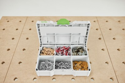 Compact Festool MINI Systainer3 in white with green latch organizing assorted small hardware on a woodworking table