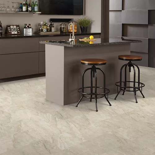Light gray vinyl flooring with subtle stone texture in modern kitchen featuring island and metal bar stools
