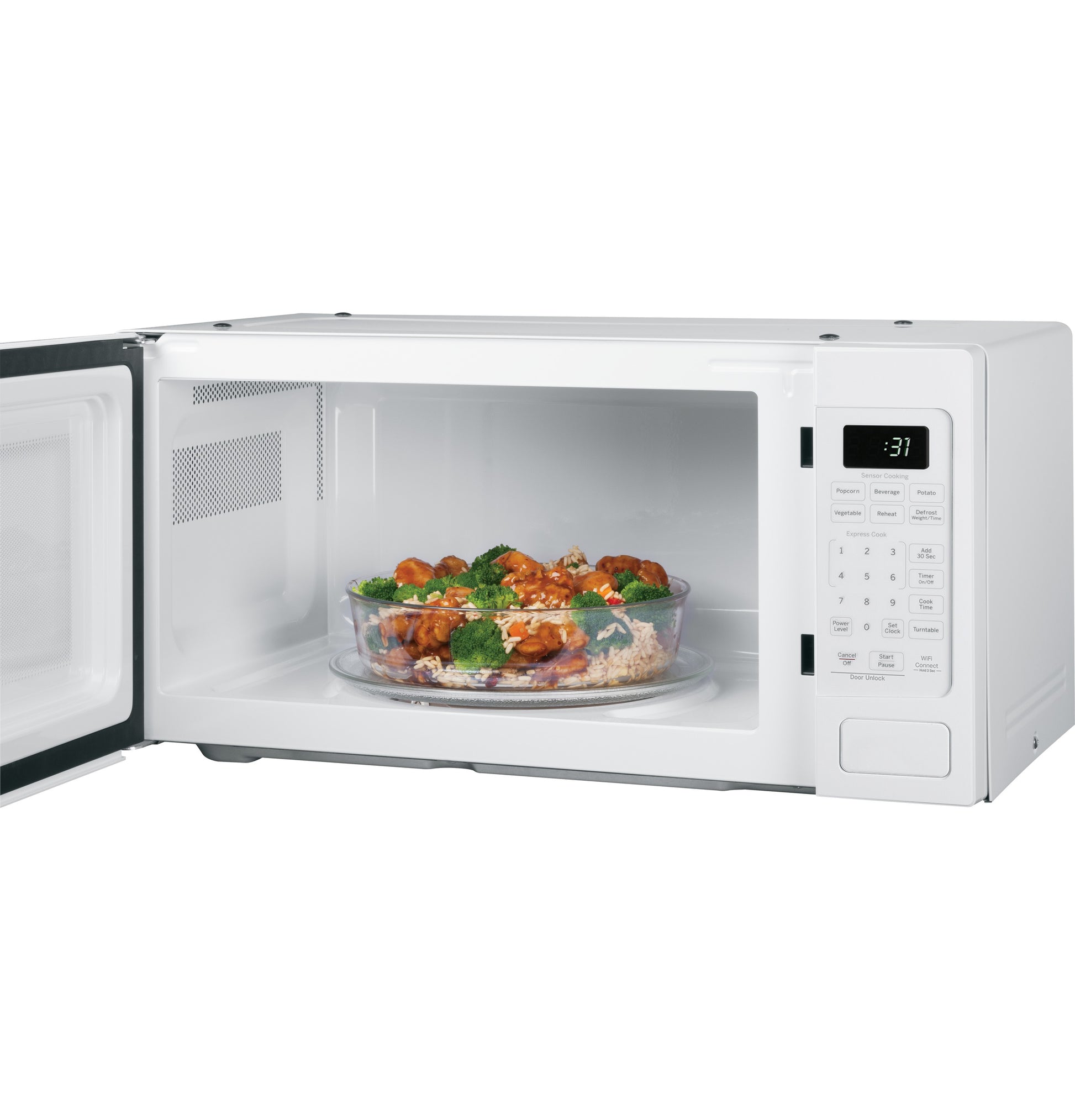 White countertop microwave oven open with glass bowl of food inside on turntable in kitchen appliances collection