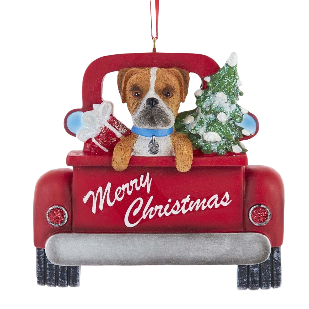 Resin Christmas ornament with a Boxer dog in a red truck carrying a tree and gifts, festive holiday decor