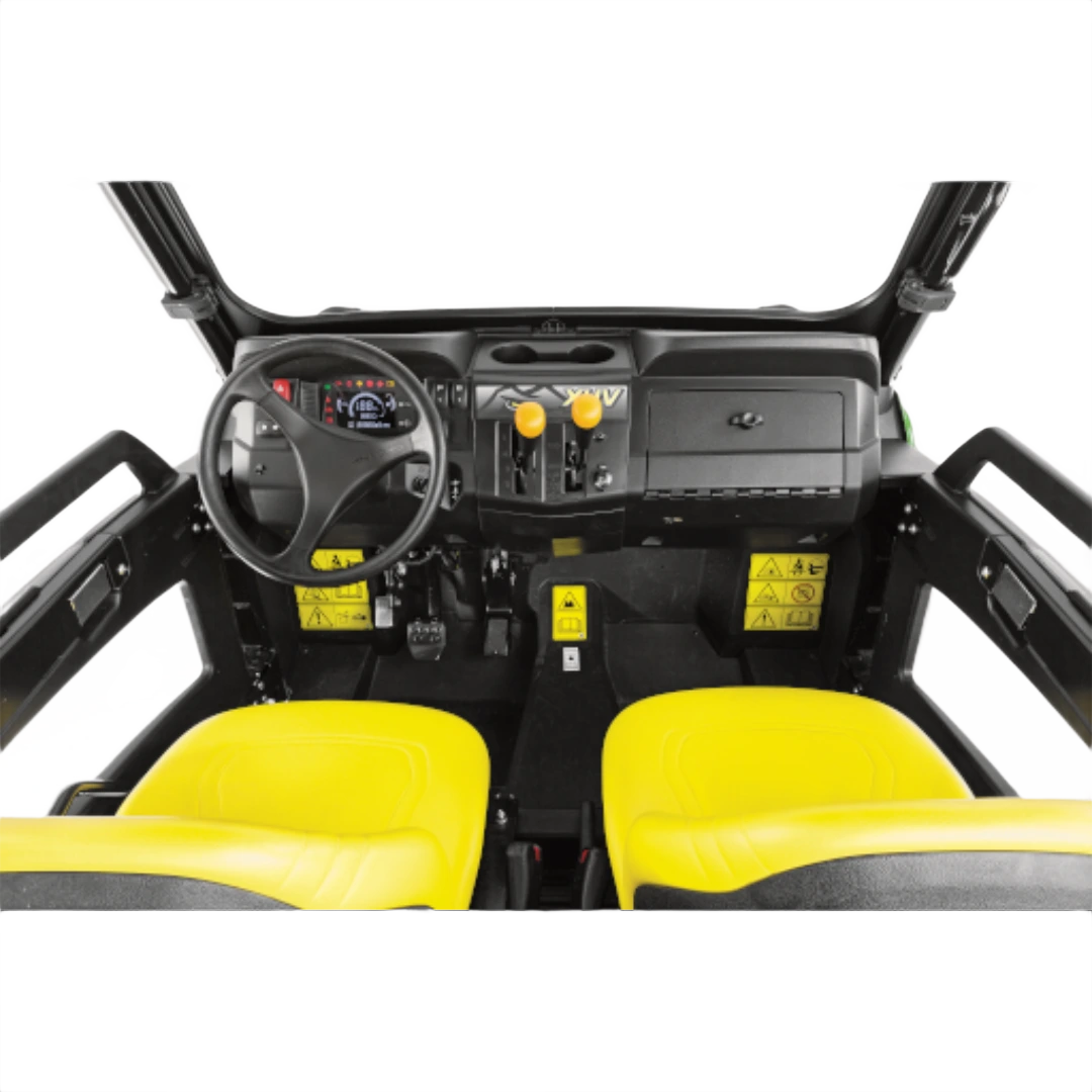 Interior view of a John Deere XUV590M mid-size utility vehicle featuring yellow bucket seats, steering wheel, dashboard controls, and enclosed cabin at Hartville Hardware.