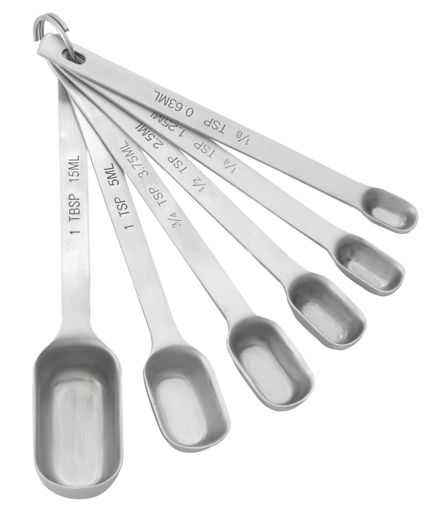 Set of stainless steel measuring spoons with etched volume markings linked by metal ring for kitchen use in home improvement projects