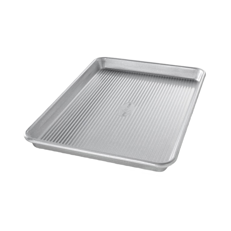 Durable metal baking pan with ribbed surface designed for easy jelly roll baking and home kitchen use