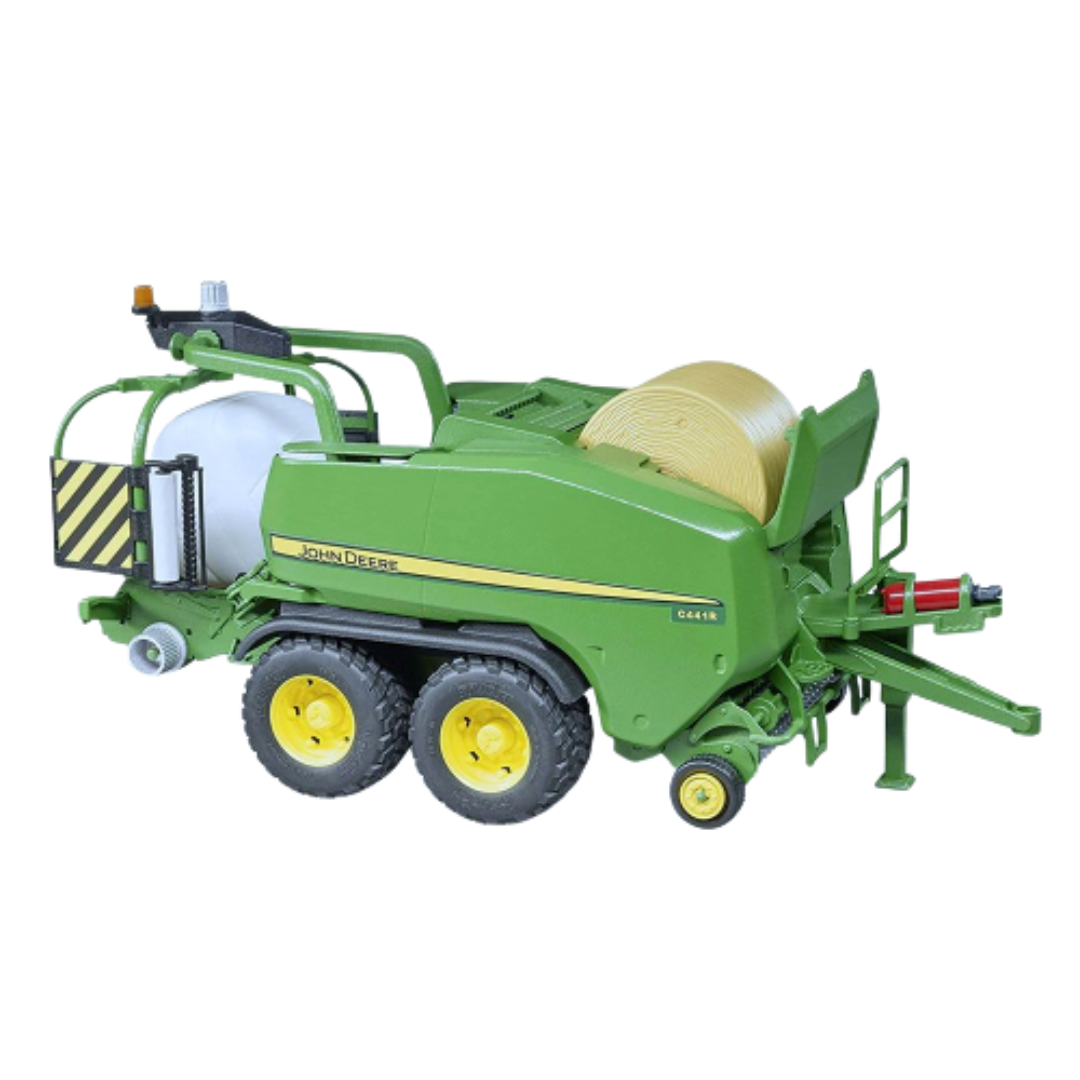 Green toy wrapping chamber baler with yellow wheels and rotating bale from Bruder Toys in Vehicles & Remote Controlled Toys collection