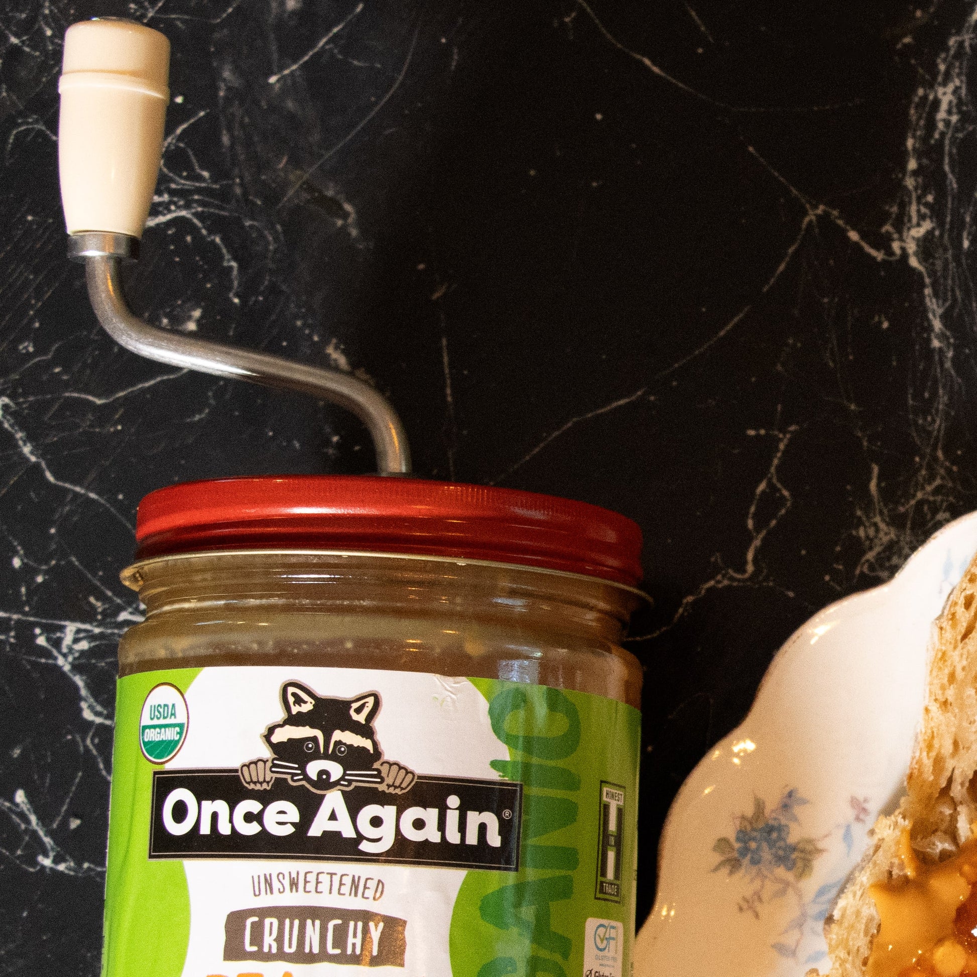 Old fashioned peanut butter stirrer with white handle twisting oil in a jar, part of kitchen utensils under $50 collection